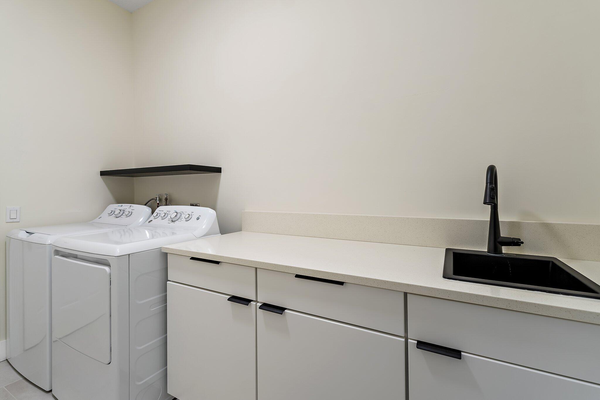 173 East Hampton Way Jupiter, FL 33458 - Photo 23 of 28 a view of storage and utility room with washer and dryer