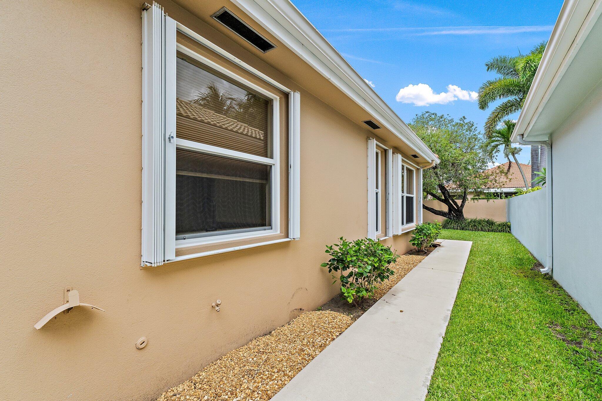 173 East Hampton Way Jupiter, FL 33458 - Photo 25 of 28 a front view of a house with a yard
