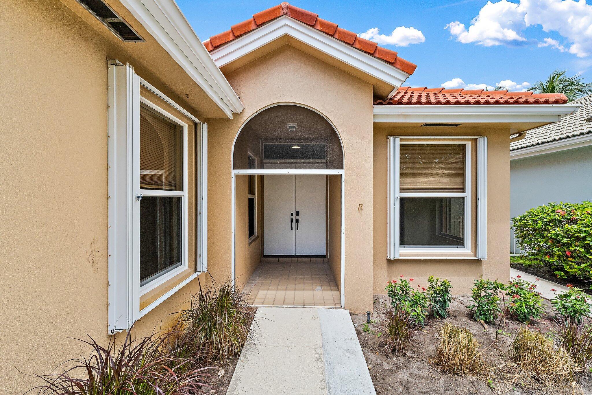 173 East Hampton Way Jupiter, FL 33458 - Photo 4 of 28 a view of a house with a porch