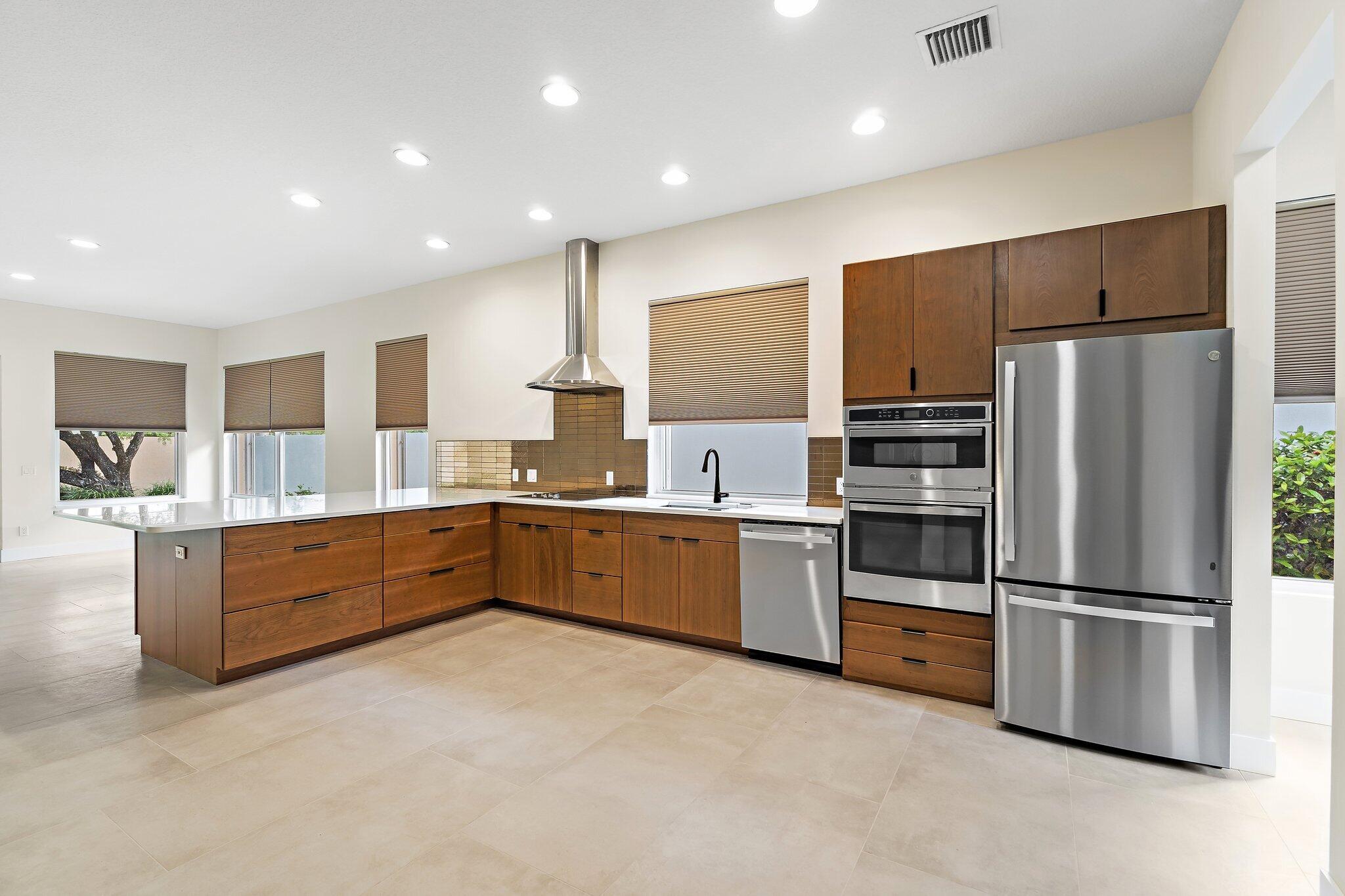 173 East Hampton Way Jupiter, FL 33458 - Photo 6 of 28 a large kitchen with stainless steel appliances and refrigerator