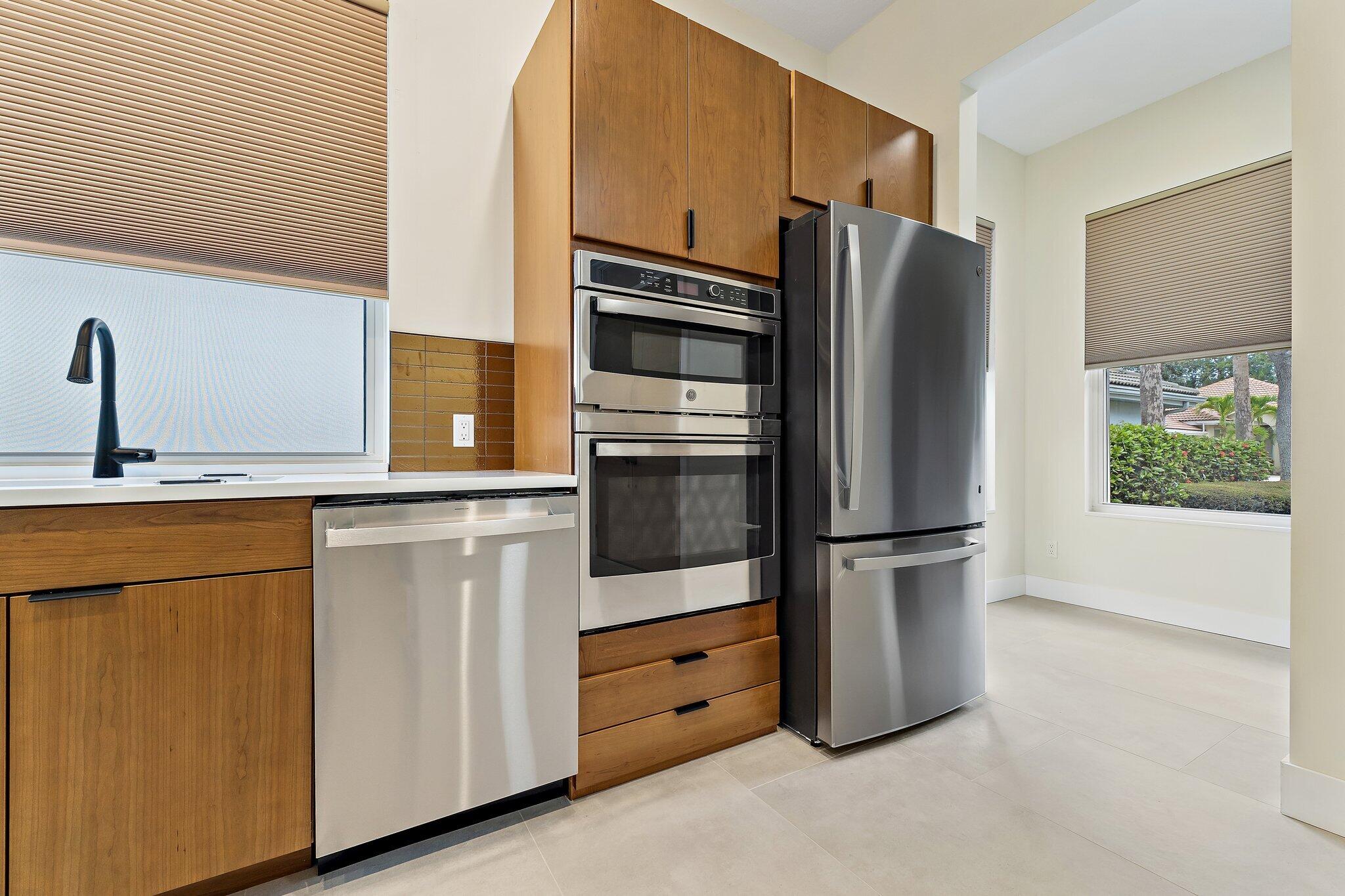 173 East Hampton Way Jupiter, FL 33458 - Photo 9 of 28 a kitchen with stainless steel appliances a refrigerator stove and microwave