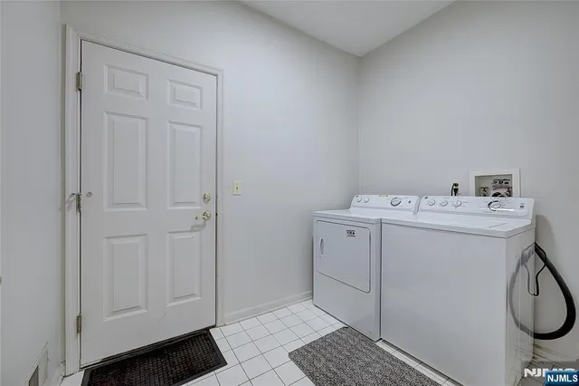 a utility room with cabinets washer and dryer