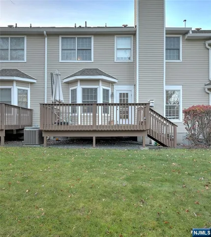 a view of a house with a yard and deck