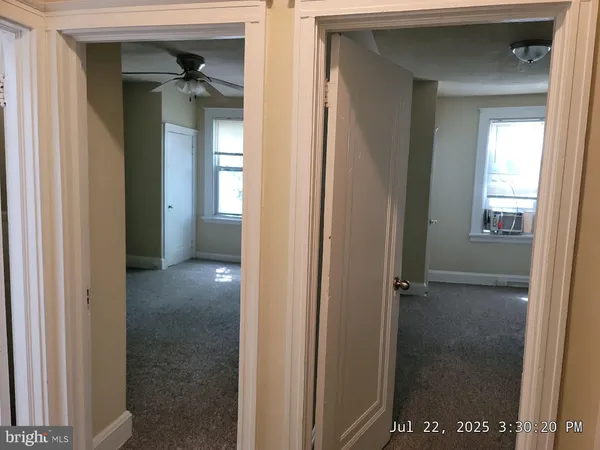 a view of a bathroom from a hallway