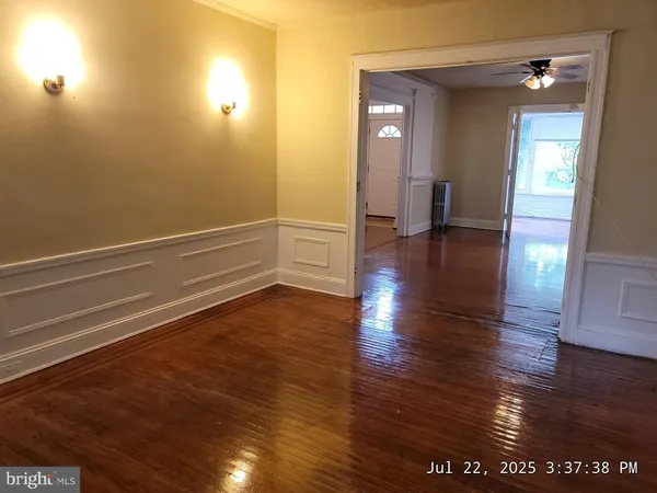 a view of a room with wooden floor and potted plant