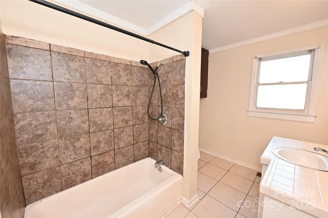 a bathroom with a bathtub and shower