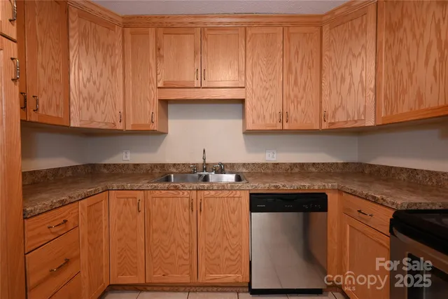 a kitchen with granite countertop wooden cabinets
