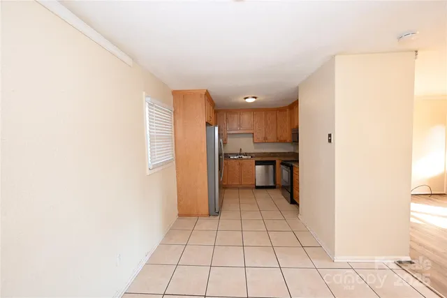 a view of a kitchen with a sink and a refrigerator