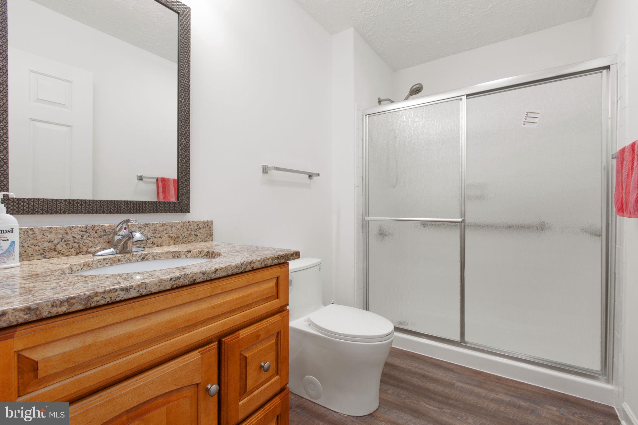 8401 Seays Road Spotsylvania, VA 22551 - Photo 16 of 32 Full bathroom with stall shower and LVP flooring