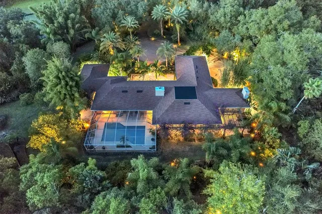 an aerial view of a house with yard swimming pool and outdoor seating