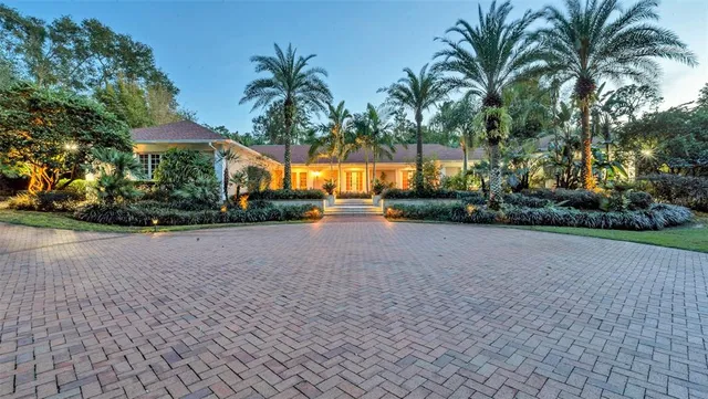a living room with furniture a fireplace and a floor to ceiling window