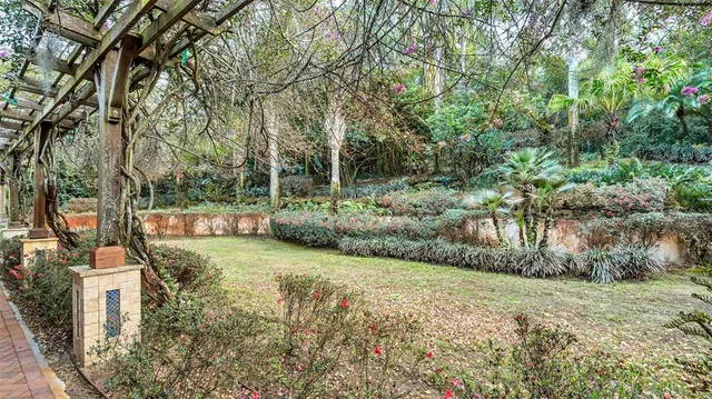 a front view of a house with a garden and a yard
