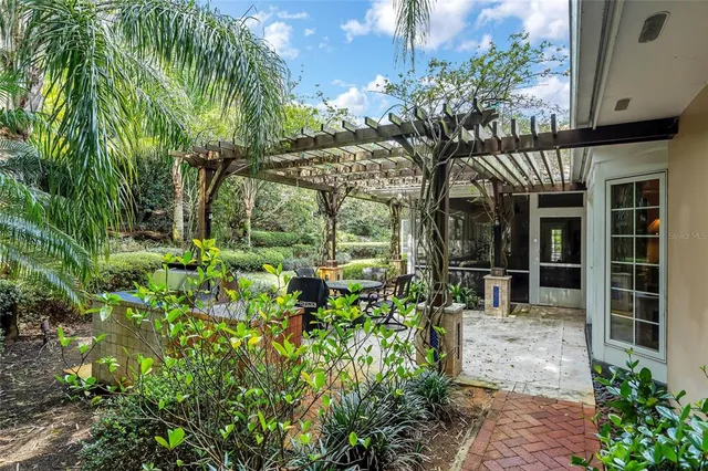 a kitchen with stainless steel appliances kitchen island granite countertop a table chairs and a refrigerator