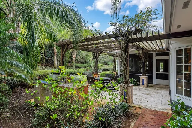 a kitchen with granite countertop kitchen island stainless steel appliances a sink stove and cabinets
