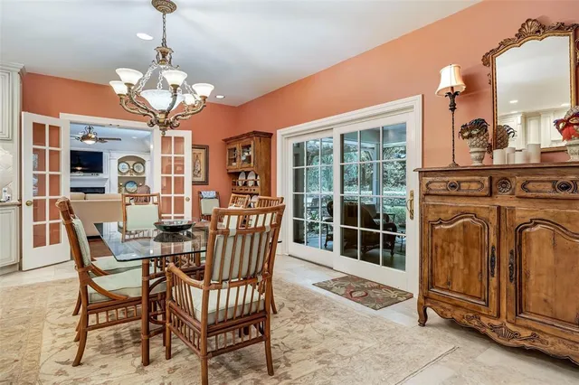 a view of a backyard with a floor to ceiling window and potted plants
