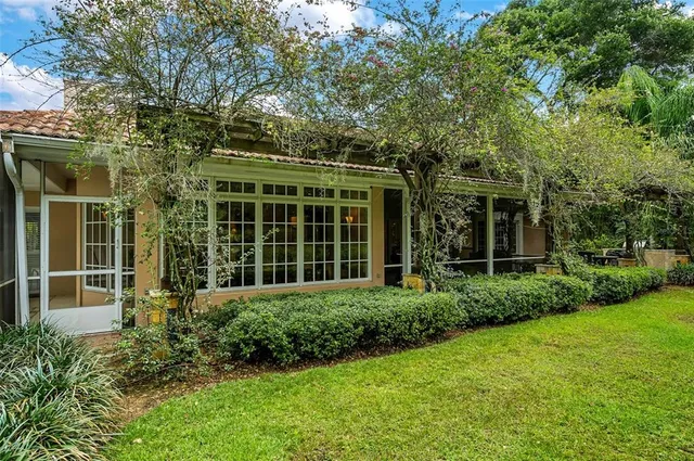 an aerial view of a house with yard swimming pool and outdoor seating