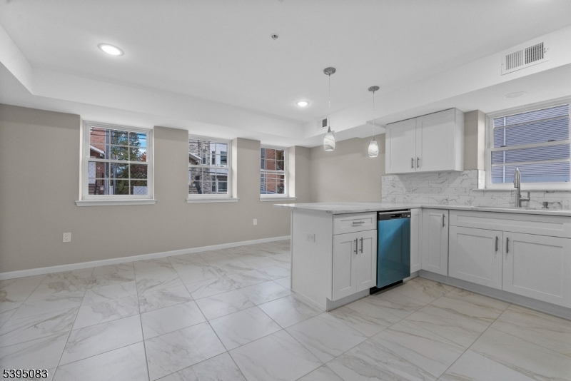 24 Garibaldi Avenue Newark, NJ 07114 - Photo 5 of 13 a kitchen with granite countertop a stove sink and cabinets