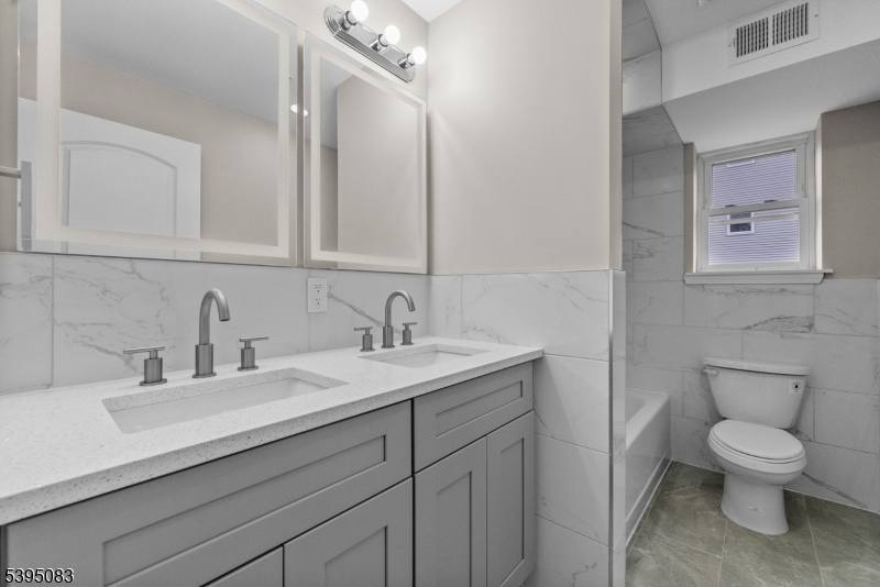 24 Garibaldi Avenue Newark, NJ 07114 - Photo 7 of 13 a bathroom with a toilet a sink and mirror