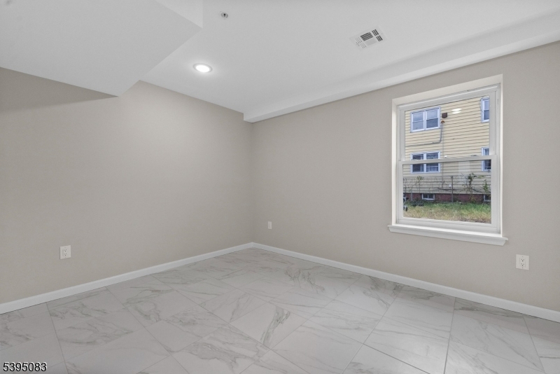 24 Garibaldi Avenue Newark, NJ 07114 - Photo 8 of 13 a view of an empty room with a window