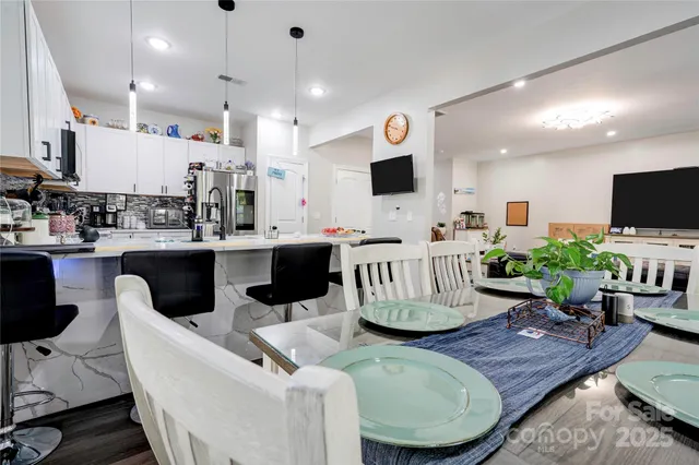 a living room with lots of furniture and kitchen view