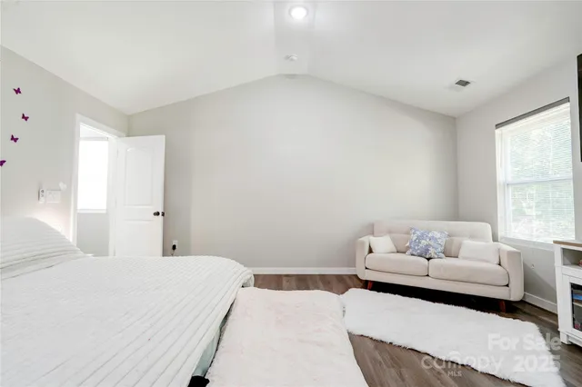 a bedroom with a bed and a couch