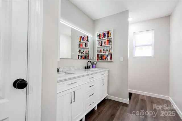 a kitchen with a sink a window and cabinets