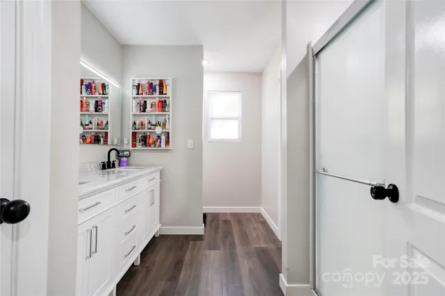 a hallway with cabinets and wooden floor