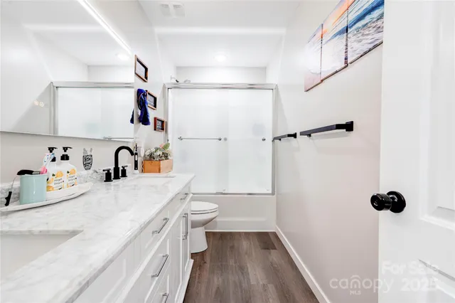 a bathroom with a sink toilet and shower