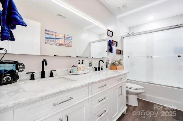 a view of a double vanity sink and a toilet