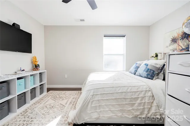 a bedroom with a bed and flat screen tv