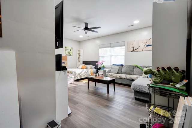 a living room with furniture and a wooden floor