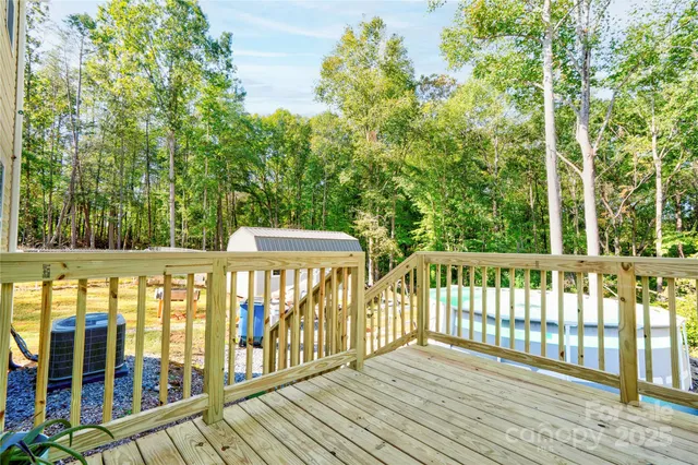 a view of balcony with wooden floor and fence