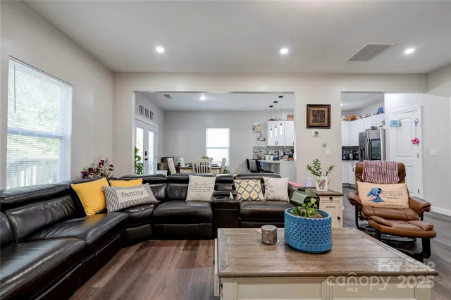 a living room with furniture a rug and a window