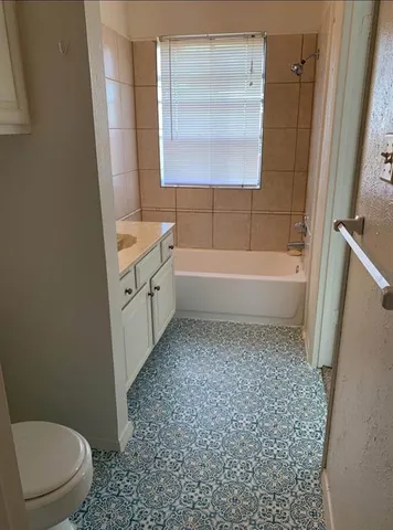 a bathroom with a sink a toilet and bathtub