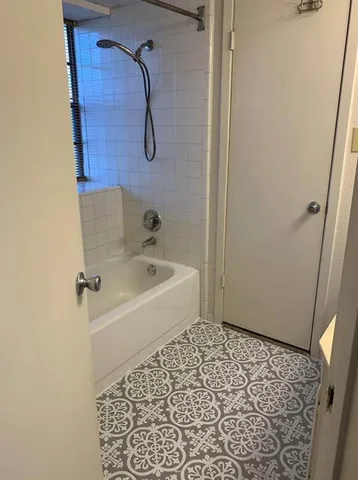 a bathroom with a bathtub and shower