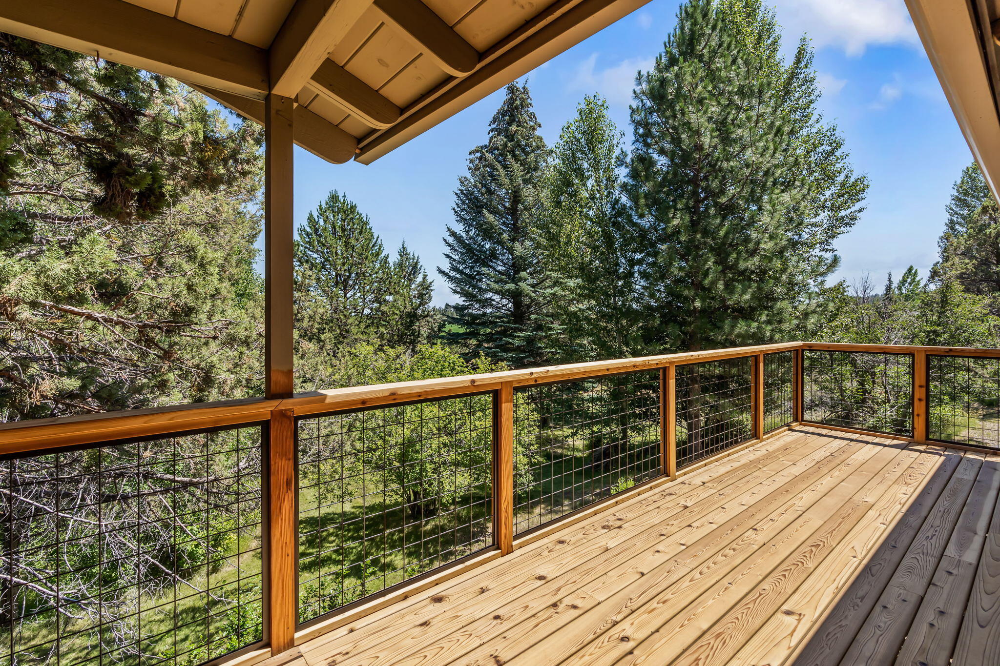 65161 Smokey Butte Road Bend, OR 97703 - Photo 25 of 45 a view of balcony with wooden floor and fence