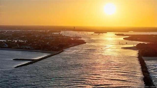 a view of a patio with couches and swimming pool