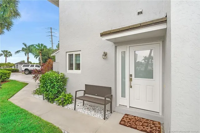 a kitchen with a table chairs sink and cabinets