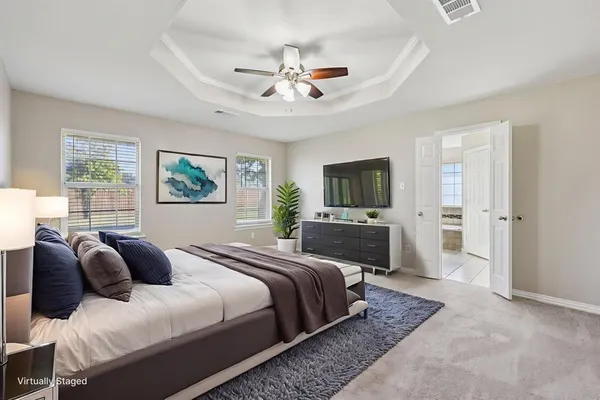 a bedroom with a large bed and a tv