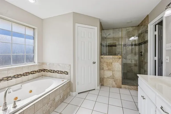 a bathroom with a bathtub and shower