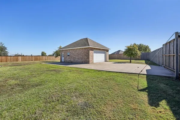 a house with green field in front of it