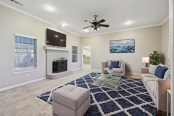 a living room with furniture a flat screen tv and a fireplace