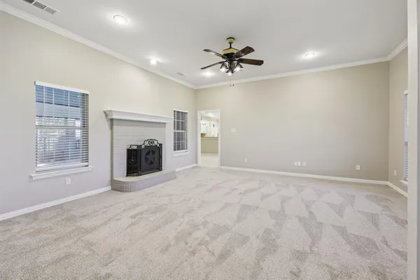 a view of an empty room with a fireplace and a window
