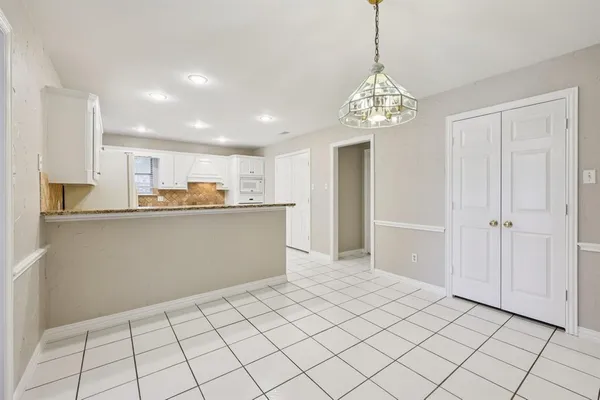 a view of a kitchen with a sink and cabinets