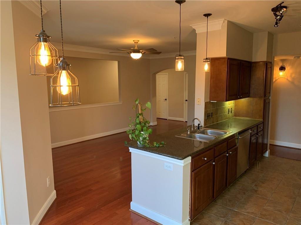 7701 Rialto Boulevard, Unit 1222 Austin, TX 78735 - Photo 3 of 14 A well-appointed kitchen island with dual sinks anchors this open-concept living space.