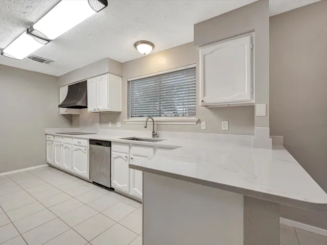 a kitchen with stainless steel appliances granite countertop a sink and a stove