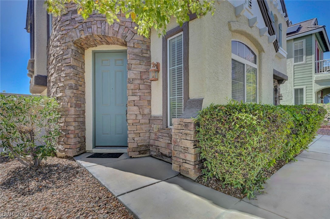 977 Sparkling Light Street Henderson, NV 89052 - Photo 16 of 75 This charming home showcases a unique stone facade with inviting entry and well-maintained landscaping.