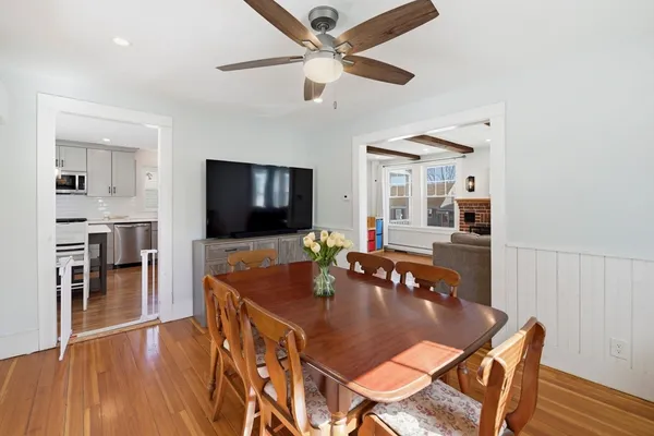 a dining room with furniture and wooden floor
