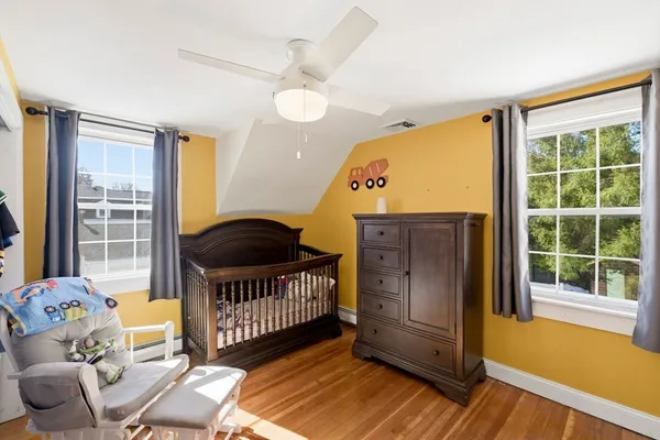 a view of a bedroom with furniture and wooden floor