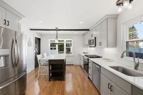 a kitchen with granite countertop a sink appliances cabinets and counter space